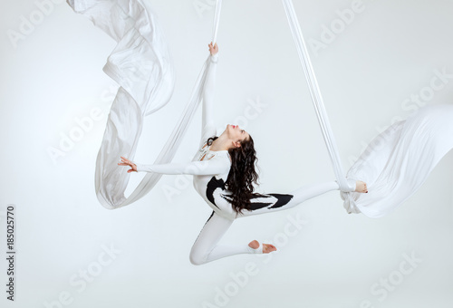 Aerial artistic acrobatics, a woman demonstrates poses.