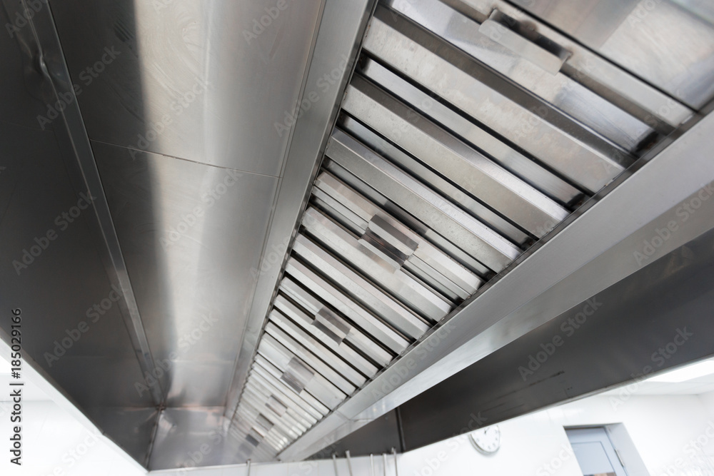 Steel shiny clean cooker hood in a restaurant Steel shiny clean cooker hood in a restaurant