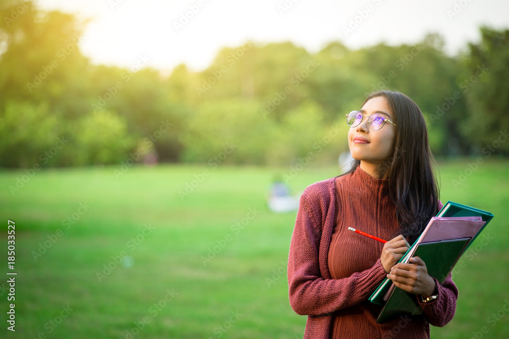 Portrait of high school girl with books in park, education concept Portrait of high school girl with books in park, education concept