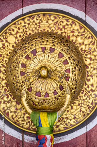 Beautiful golden door handle in the Rumtek Monastery in Gangtok, india. Architecture detail close-up