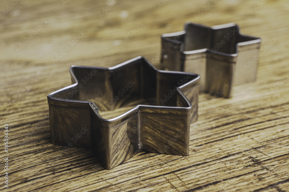 Star shaped pastry cutters on a wooden background Star shaped pastry cutters on a wooden background