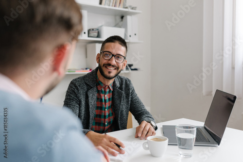 Company recruiter warmly welcomes a job candidates at a job interview