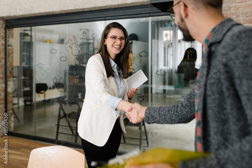 Openly greeting a job recruiter with a firm handshake photo