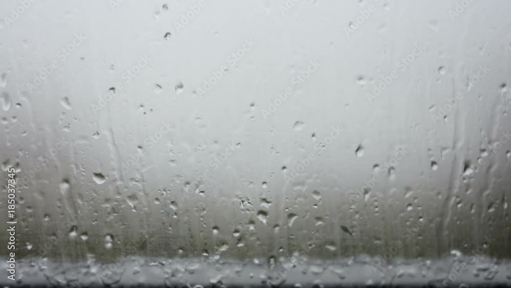 Raindrops running down on a window glass. Raindrops running down on a window glass.