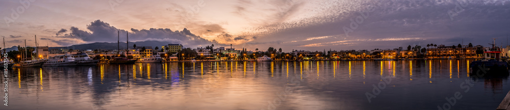 Kos town harbour panorama at sunset 