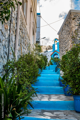 A stairway on a small alley leading to a church in the island of Kalymnos, Greece  photo