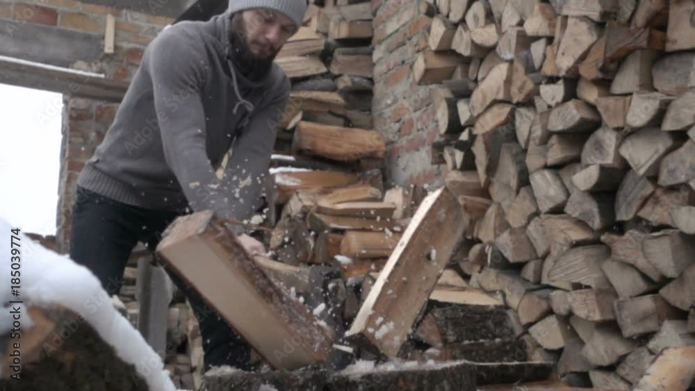 A man cuts wood logs with an ax. Felling of trees. A pile of sawn firewood. Chop wood with an ax. A man cuts wood logs with an ax. Felling of trees. A pile of sawn firewood. Chop wood with an ax.