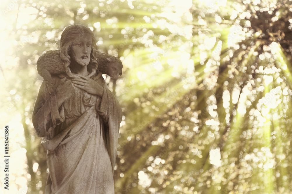 Ancient statue of Jesus Christ Good Shepherd in sun rays (faith, religion, Christianity, God concept) Ancient statue of Jesus Christ Good Shepherd in sun rays (faith, religion, Christianity, God concept)