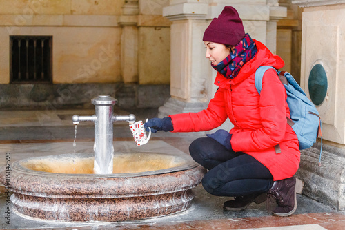 Konstfotografi A tourist woman drinks water from a medicinal thermal spring in Karlovy Vary, Cz