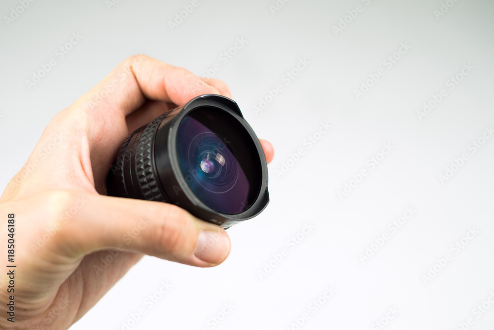 lens in hand on a white background