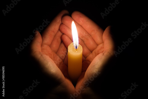 Slika na platnu hands holding a burning candle in dark like a heart
