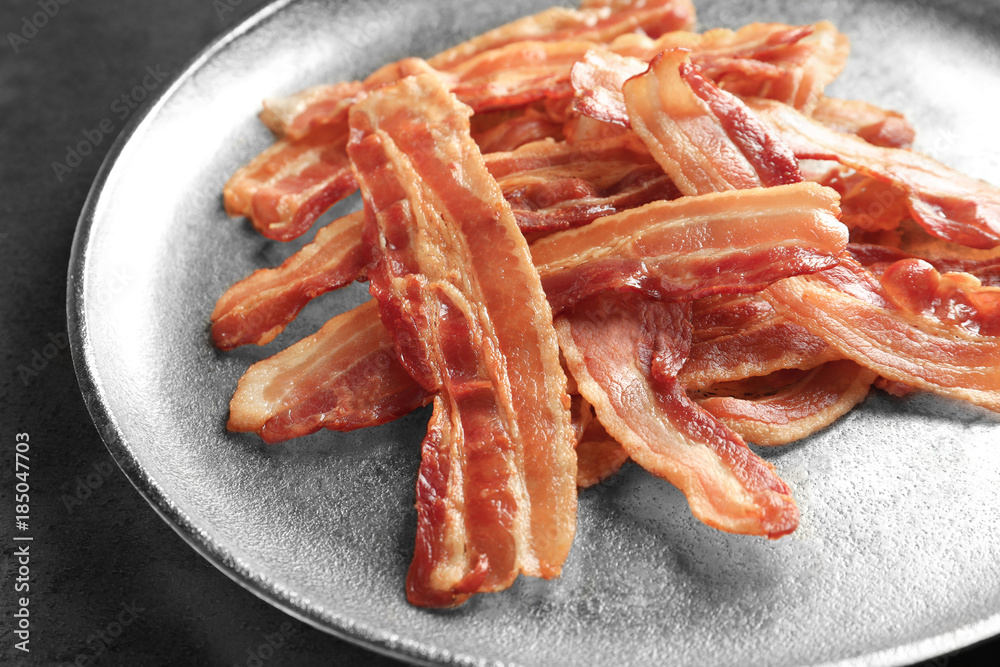 Cooked bacon rashers on plate, closeup Cooked bacon rashers on plate, closeup