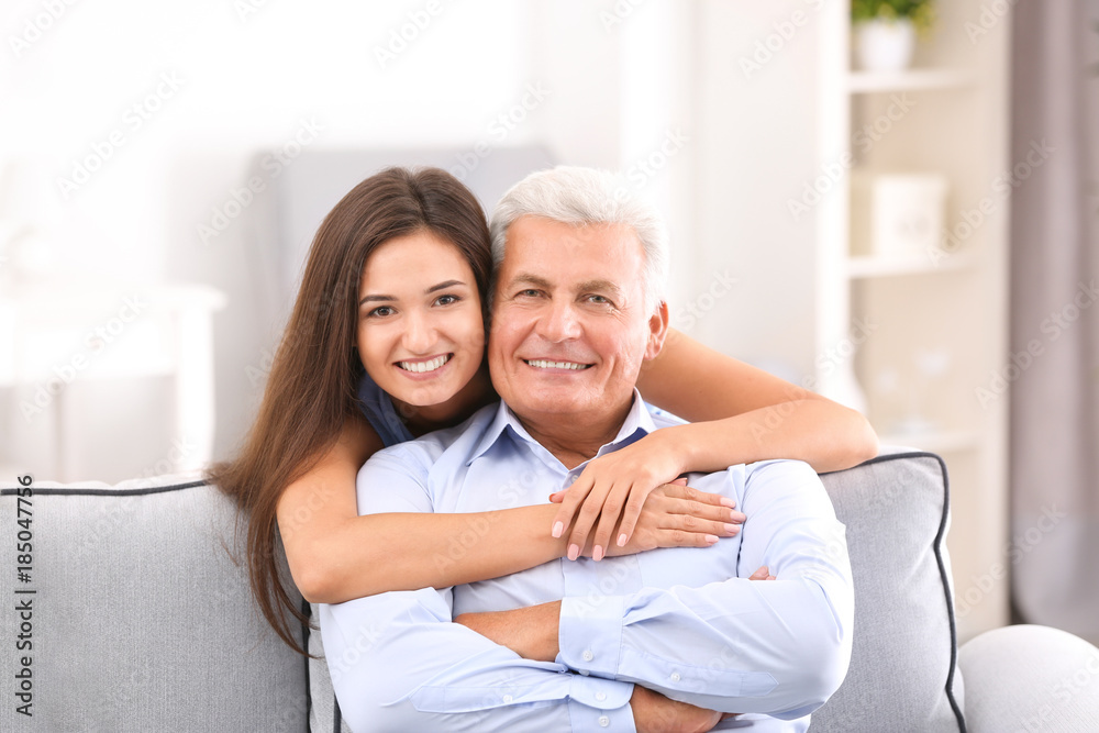 Mature man with daughter in comfortable room Mature man with daughter in comfortable room