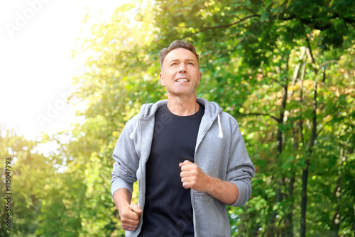 Mature sporty man running outdoors