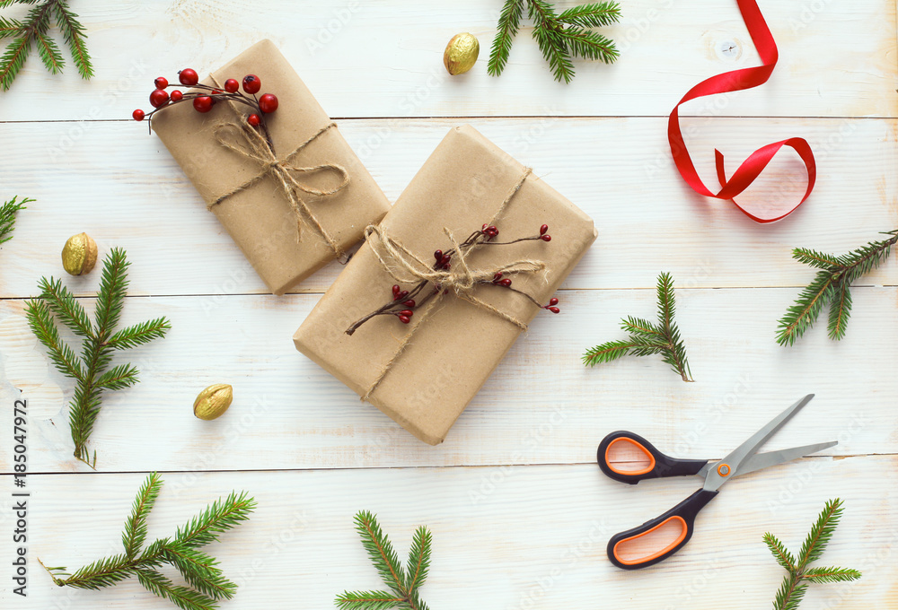 Christmas gift boxes and fir tree branch on wooden table, flat lay. Сhristmas background Christmas gift boxes and fir tree branch on wooden table, flat lay. Сhristmas background