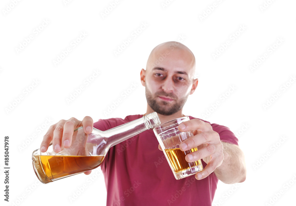 Man pouring whiskey into glass against white background. Alcoholism concept Man pouring whiskey into glass against white background. Alcoholism concept