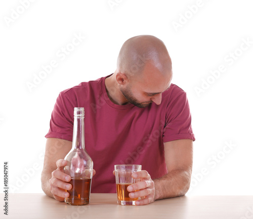 Drunk man sitting at table ...