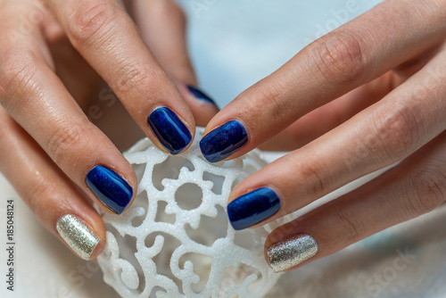 Beautiful female hands with blue manicure.