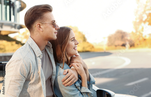 Happy young couple standing...