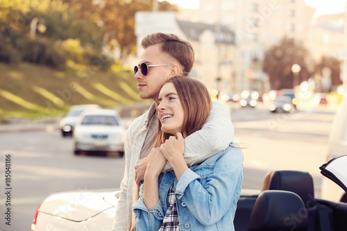Happy young couple standing...