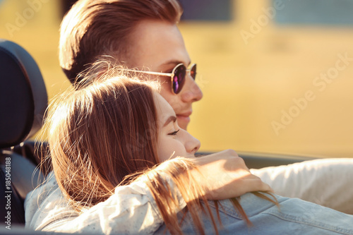 Happy young couple in car o...