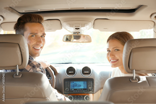 Beautiful young couple in car