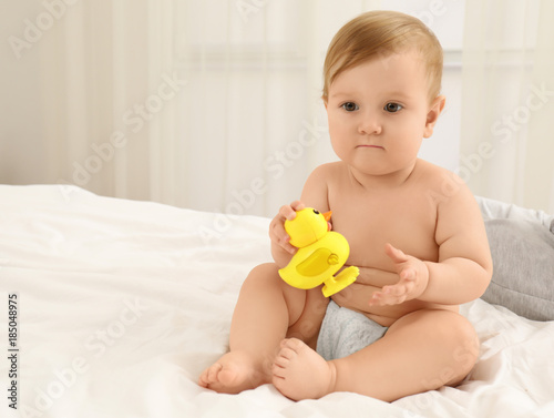 Cute little baby with toy at home