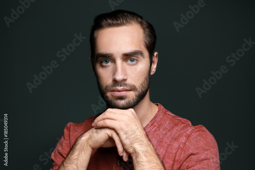 Young handsome man on color background