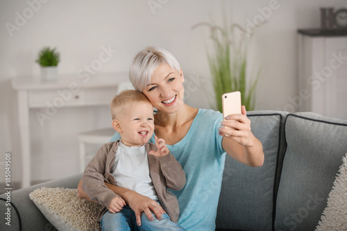 Young mother taking selfie ...