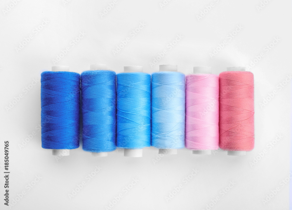 Colorful sewing threads on white background Colorful sewing threads on white background