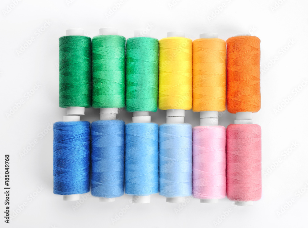 Colorful sewing threads on white background Colorful sewing threads on white background