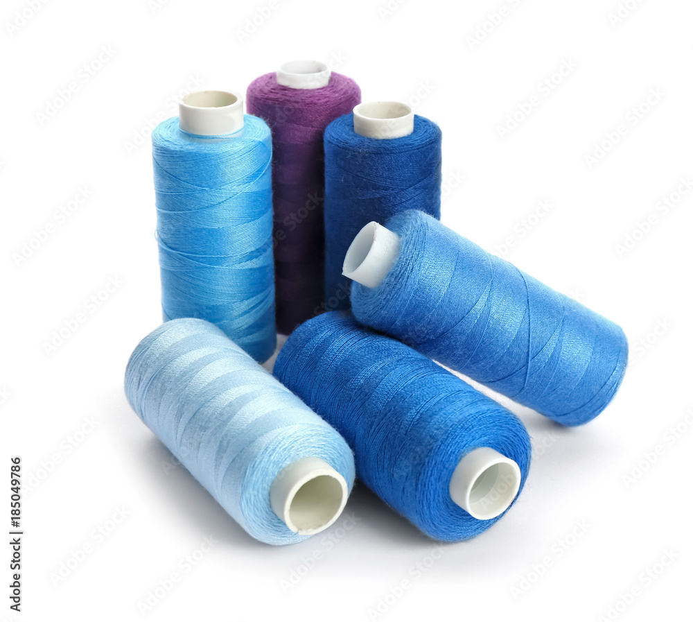 Colorful sewing threads on white background Colorful sewing threads on white background