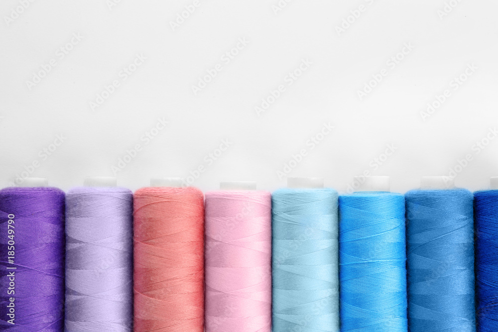 Colorful sewing threads on white background Colorful sewing threads on white background