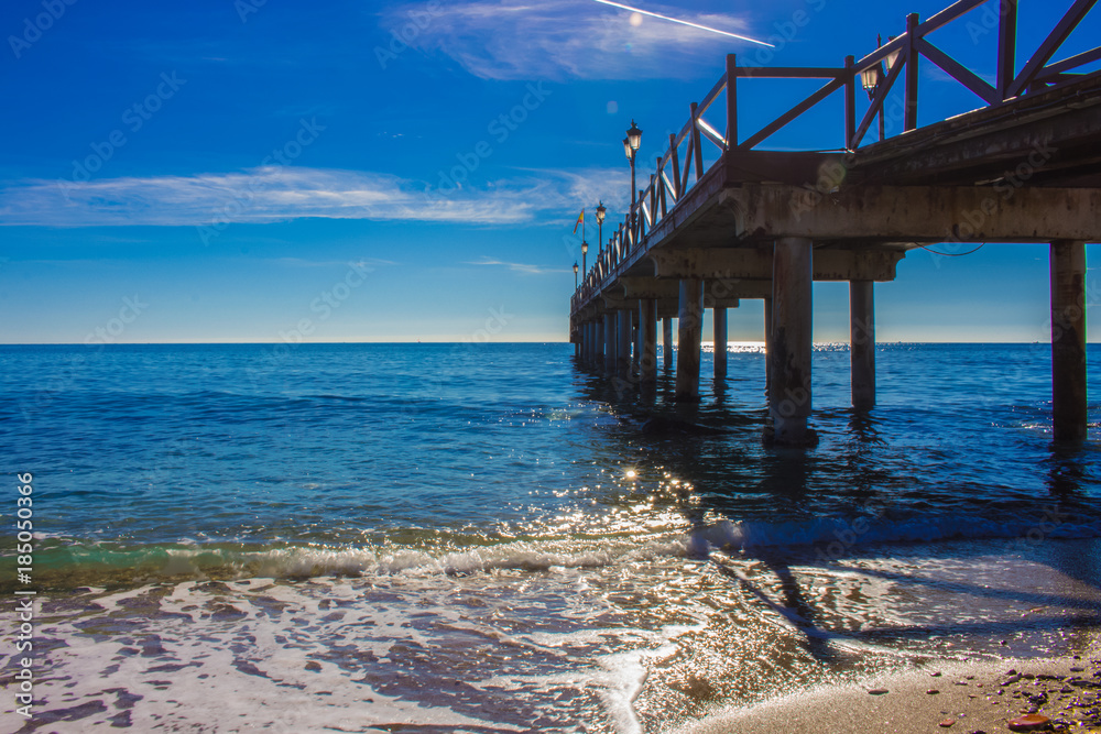 Pier. Wooden pier in Marbella. Malaga province, Costa del Sol, Andalusia, Spain. Picture taken – 14 december 2017.