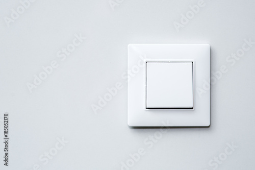 a light switch on gray wall. photo