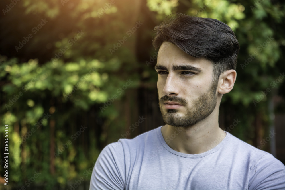 Handsome young man outdoor looking away to a side Handsome young man outdoor looking away to a side