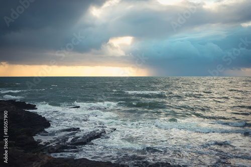 Dramatic sky over the sea  rain and sun  storm  waves in Ireland  Wexford