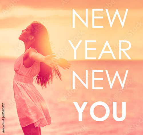 NEW YEAR, NEW YOU inspirational quote on happiness background of girl with open arms in freedom. Self esteem, self-confidence concept for new year resolution. Life change choice for the New Year.