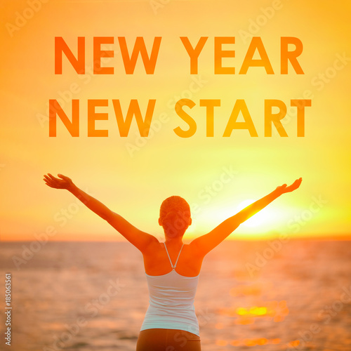 NEW YEAR NEW START motivational message, inspirational quotes for the New Year resolution in fitness weight loss. Happy woman with arms up in success winning at the sky for new life challenge.