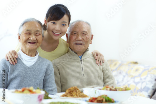 happy senior asian couple with their granddaughter in home
