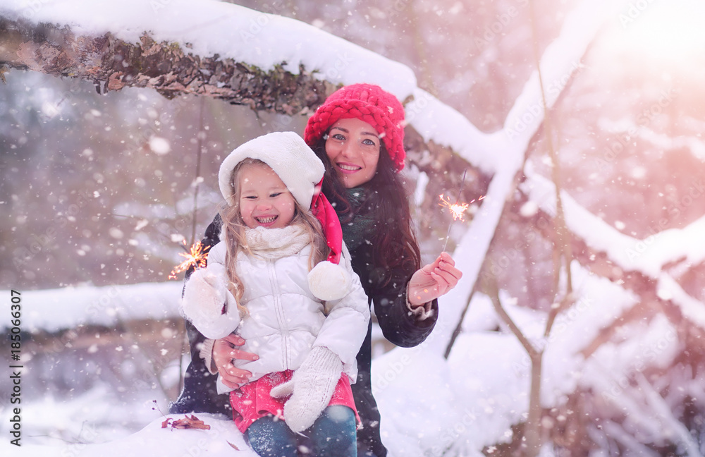 A winter fairy tale, a young mother and her daughter ride a sled A winter fairy tale, a young mother and her daughter ride a sled