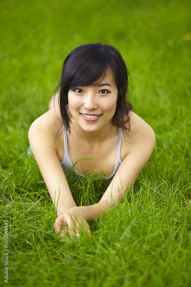 pretty young asian woman relax on grassland pretty young asian woman relax on grassland