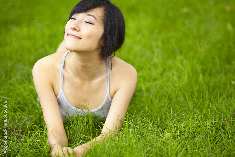 pretty young asian woman relax on grassland pretty young asian woman relax on grassland