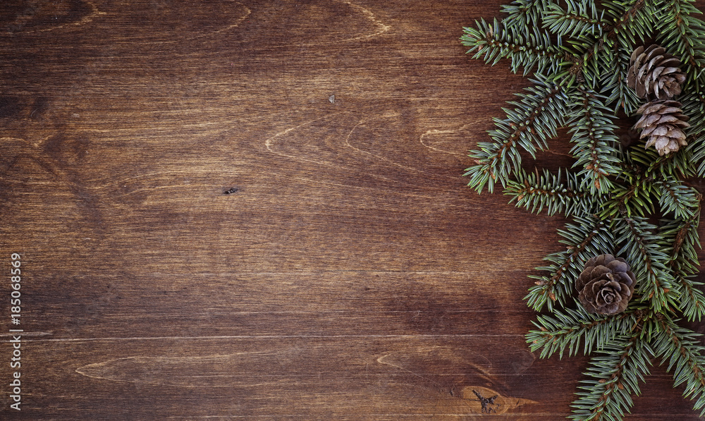 New Year's background. Spruce branches on a wooden table. Orname New Year's background. Spruce branches on a wooden table. Orname