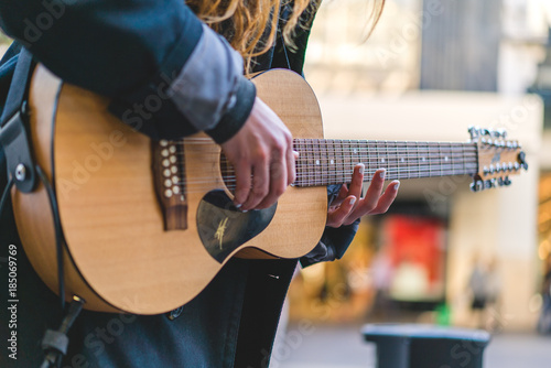 Street musician / Busker, playing guitar and singing
