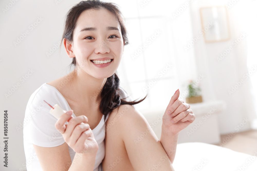 Young women paint their nails in their bedrooms Young women paint their nails in their bedrooms