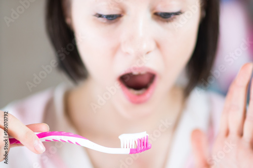 woman in the bathroom brushes teeth