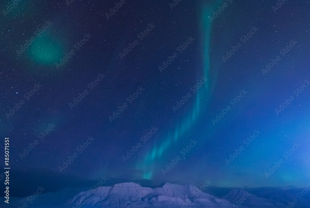 Plakat The polar arctic Northern lights aurora borealis sky star in Norway Svalbard in Longyearbyen city the moon mountains