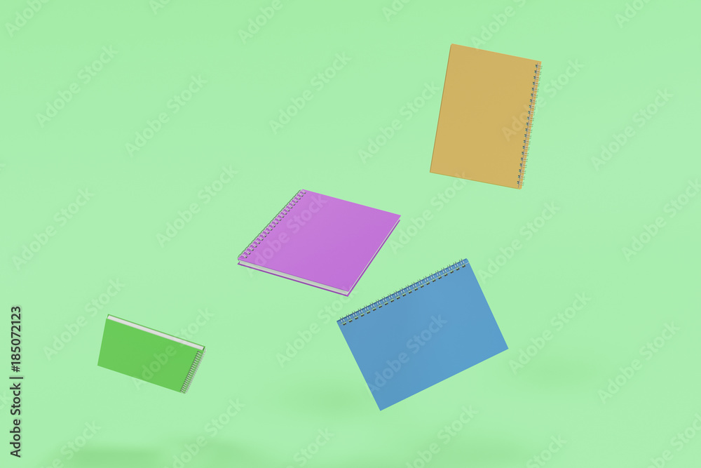Four notebooks with spiral bound on green background