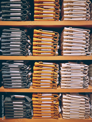 Neat Stacks Of Folded Clothing On The Shop Shelves